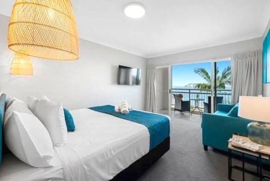 Deluxe room with warm wood tones and elegant ambient lighting